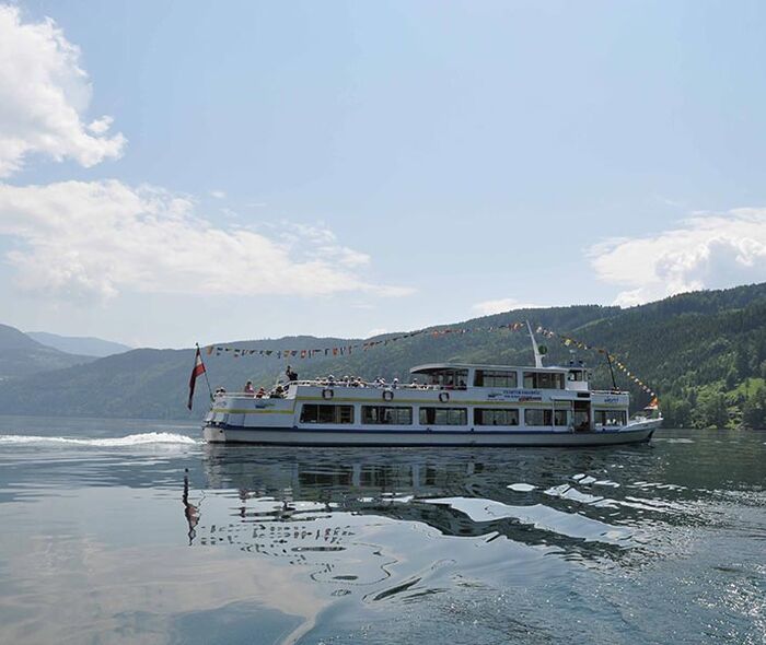 A tourist boat sailing on Lake Millstatt