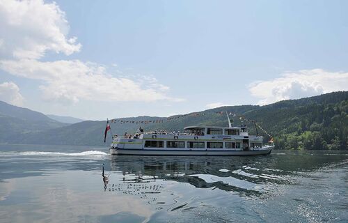 A tourist boat sailing on Lake Millstatt