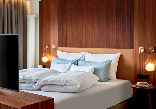 Cosy bed with TV and bedside table