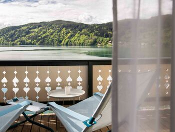 Balcony with chairs in front of the lake