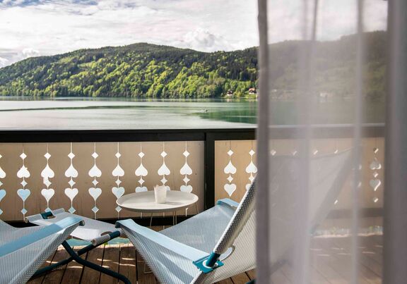 Balcony with chairs in front of the lake