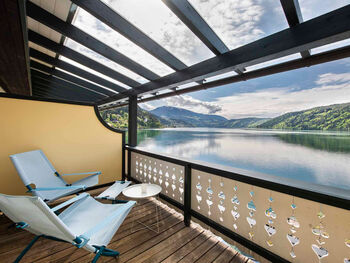 View of the lake from the balcony with 2 deckchairs
