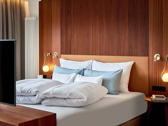 Cosy bed with TV and bedside table