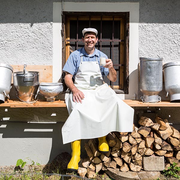 Farmer poses with milk cans