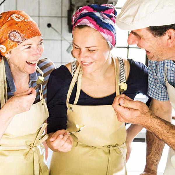 Three people taste fresh cheese