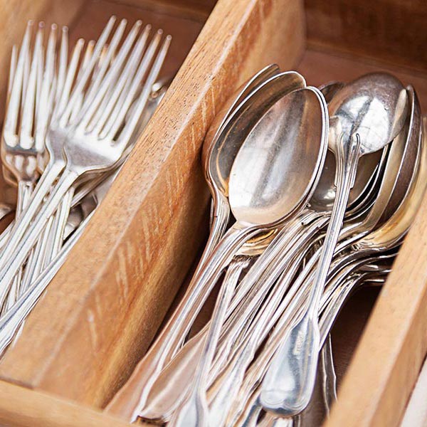 Forks and spoons are sorted separately in a drawer