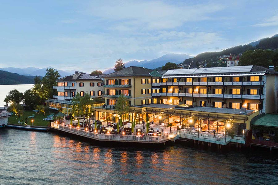 Illuminated hotel by the lake in the early evening